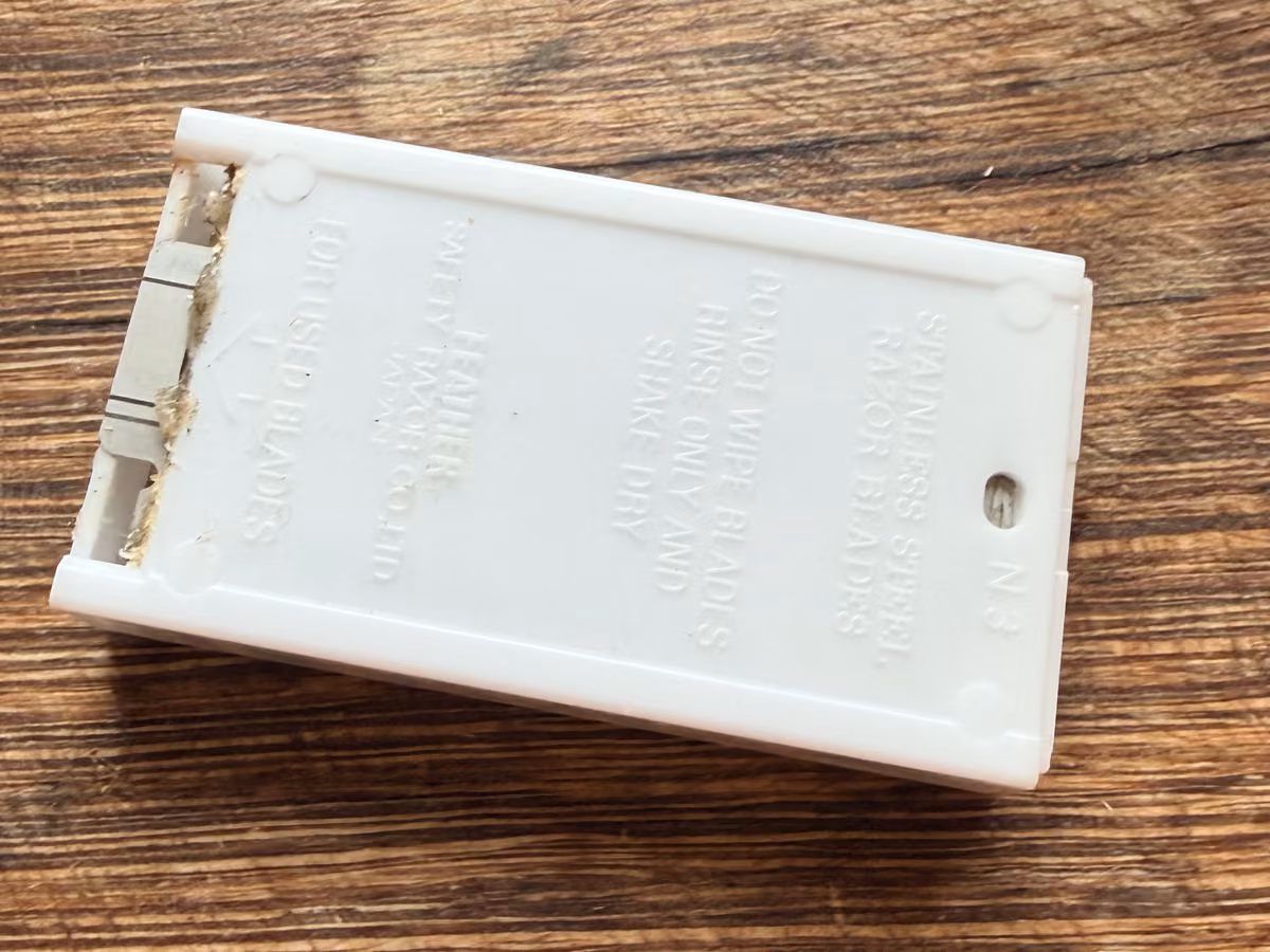 Back of the Feather dispenser showing the slot marked For used blades