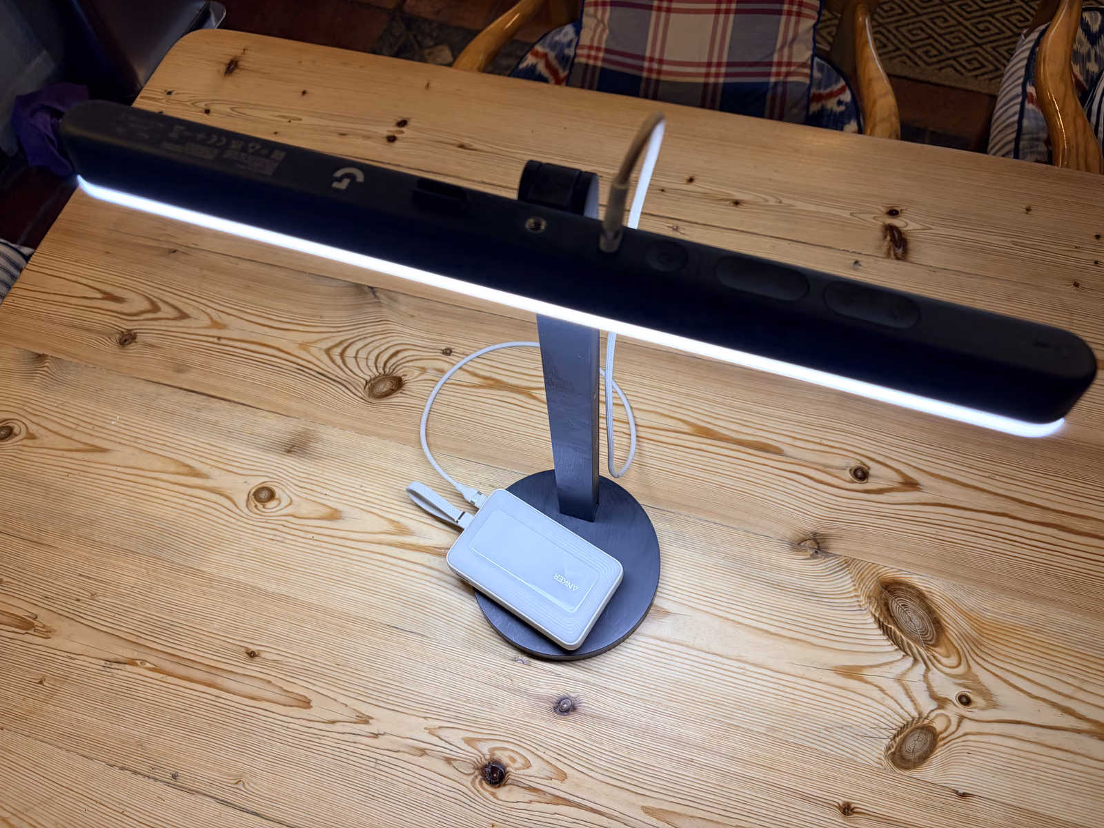 My Litra Beam angled down to illuminate the desk, with its buttons along the back